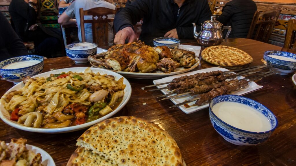 新疆餐桌上的烤羊肉、拉条子、馕与奶茶